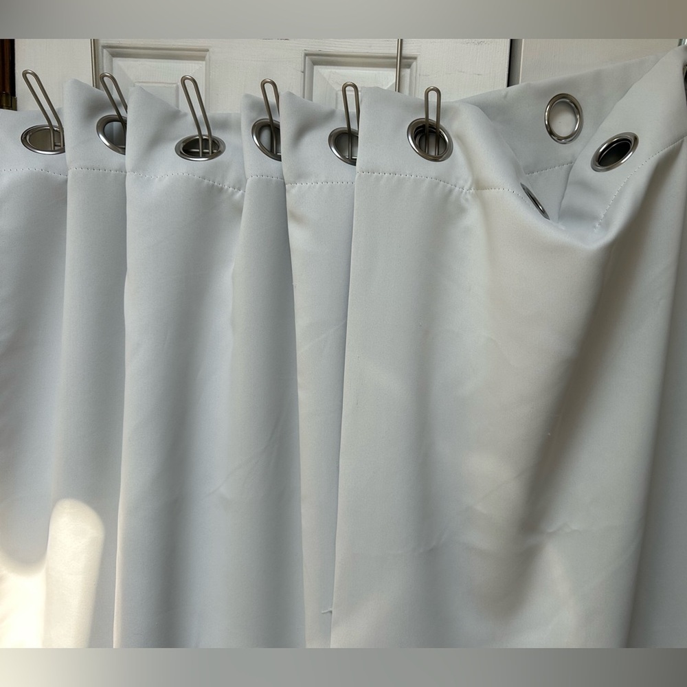 One Pair Room Darkening Drapes, pale gray, with installed 2.25” silver grommets.
